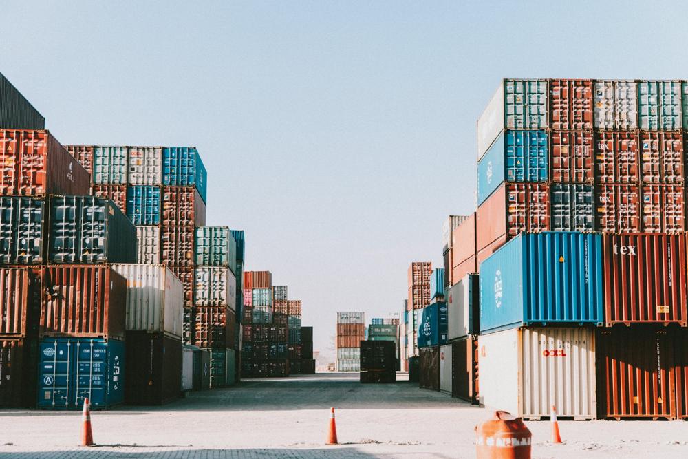 Container depot yard with stacked boxes on both sides of a lane